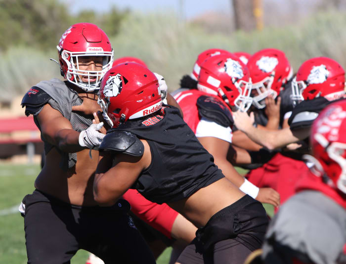 Paki Finau (left) battles with a teammate at practice.